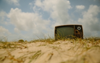an old tv on sand