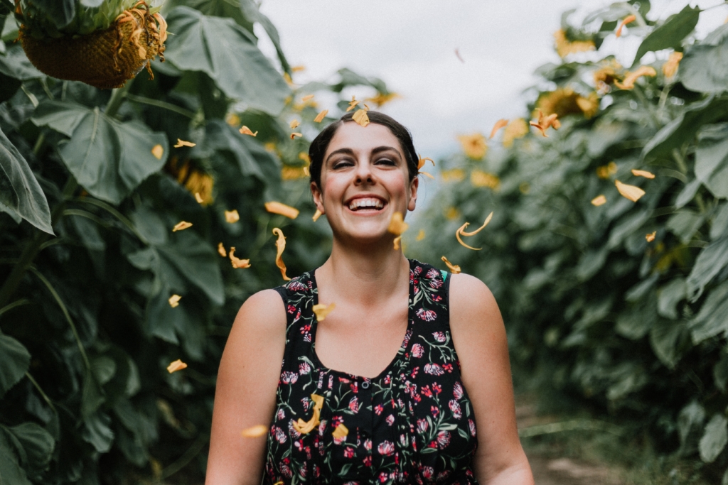 A lady smiling in a vineyard