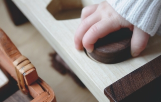 Kid playing with wooden toys