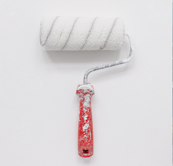 paint roller with white paint on it