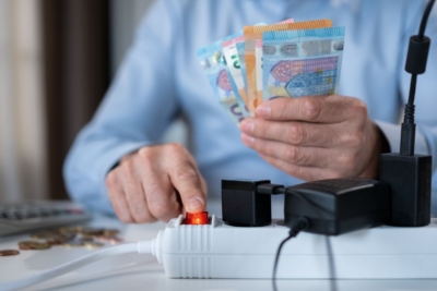 Man holding money while turning off a switch